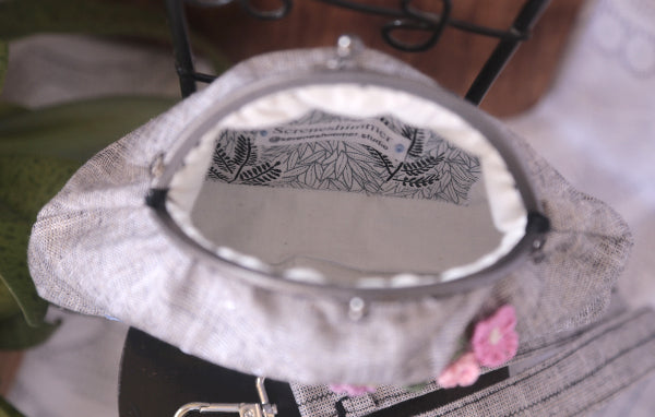 Linen purse with hand embroidered swan and flowers, showcasing intricate craft, cotton lining inside.