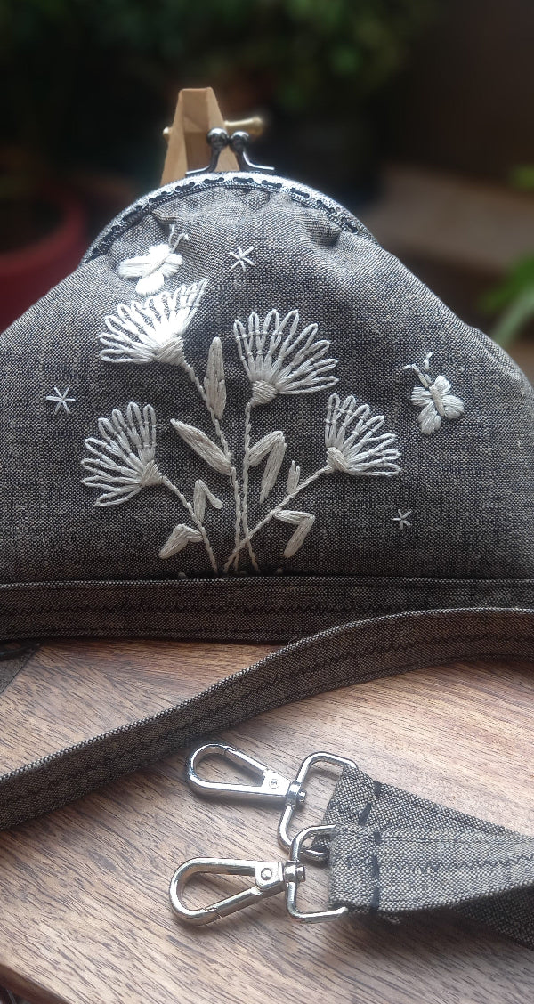 Beautiful linen purse with hand-stitched butterflies in silk thread, offering a charming vintage look in soft cream tones