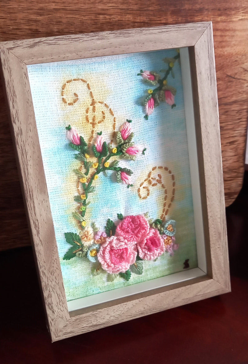 Delicate pink roses with rose buds on a lightly painted background to beautify home or workspace mounted in a modern frame.
