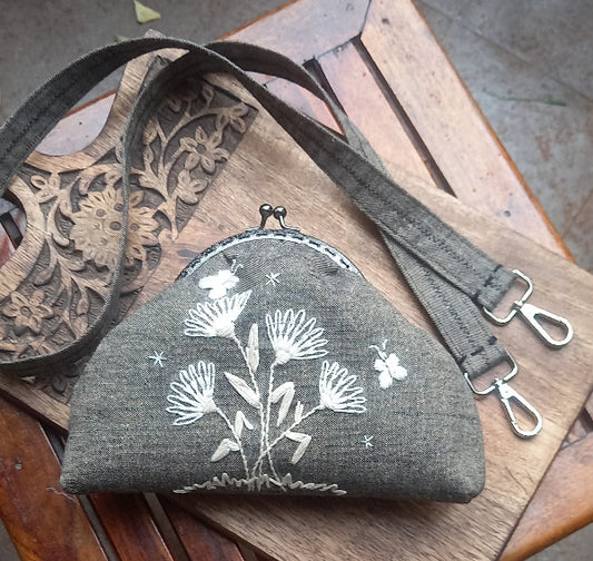 Vintage-inspired linen purse with hand-embroidered butterflies in silk thread, elegantly designed in a cream monotone