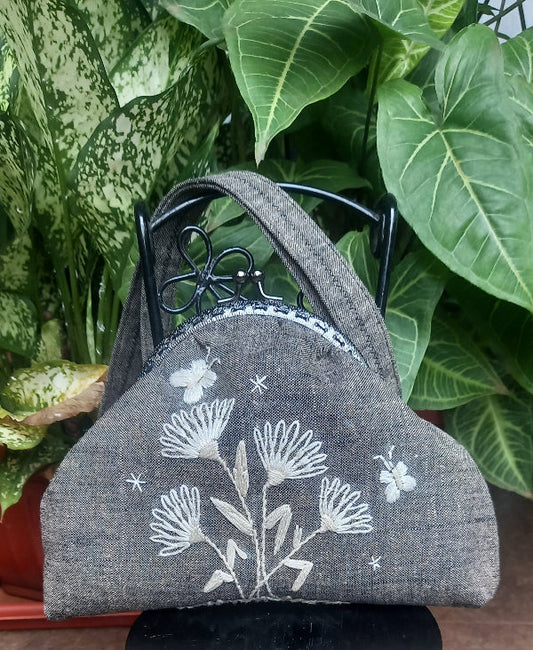 Handcrafted linen purse featuring vintage-style embroidered butterflies in silk thread, showcasing a cream monotone design