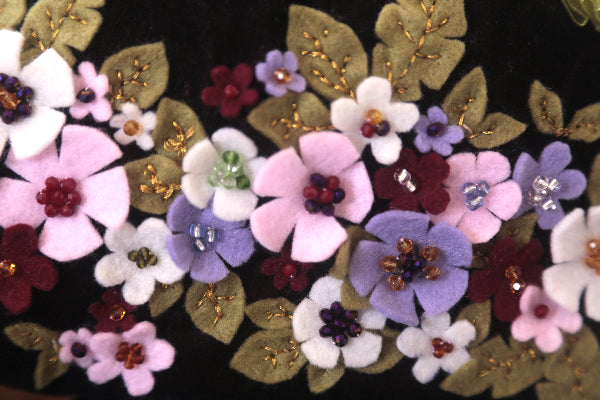 A sleek velvet purse decorated with beautiful flowers, combining elegance and fun in one stylish piece.