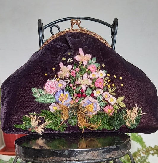 Handcrafted velvet purse featuring vintage-style hand-embroidered flowers and leaves, perfect for adding a touch of elegance