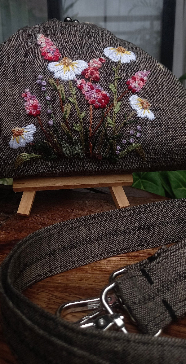 Handcrafted brownish khadi linen purse embellished with hand embroidery with pretty delicate white and pink wildflowers