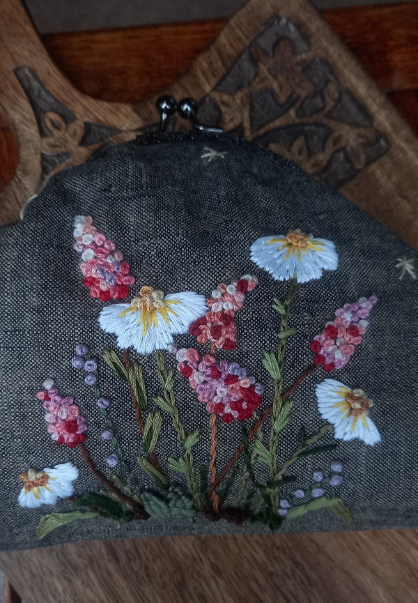 Handcrafted brownish khadi linen purse embellished with hand embroidery with pretty delicate white and pink wildflowers